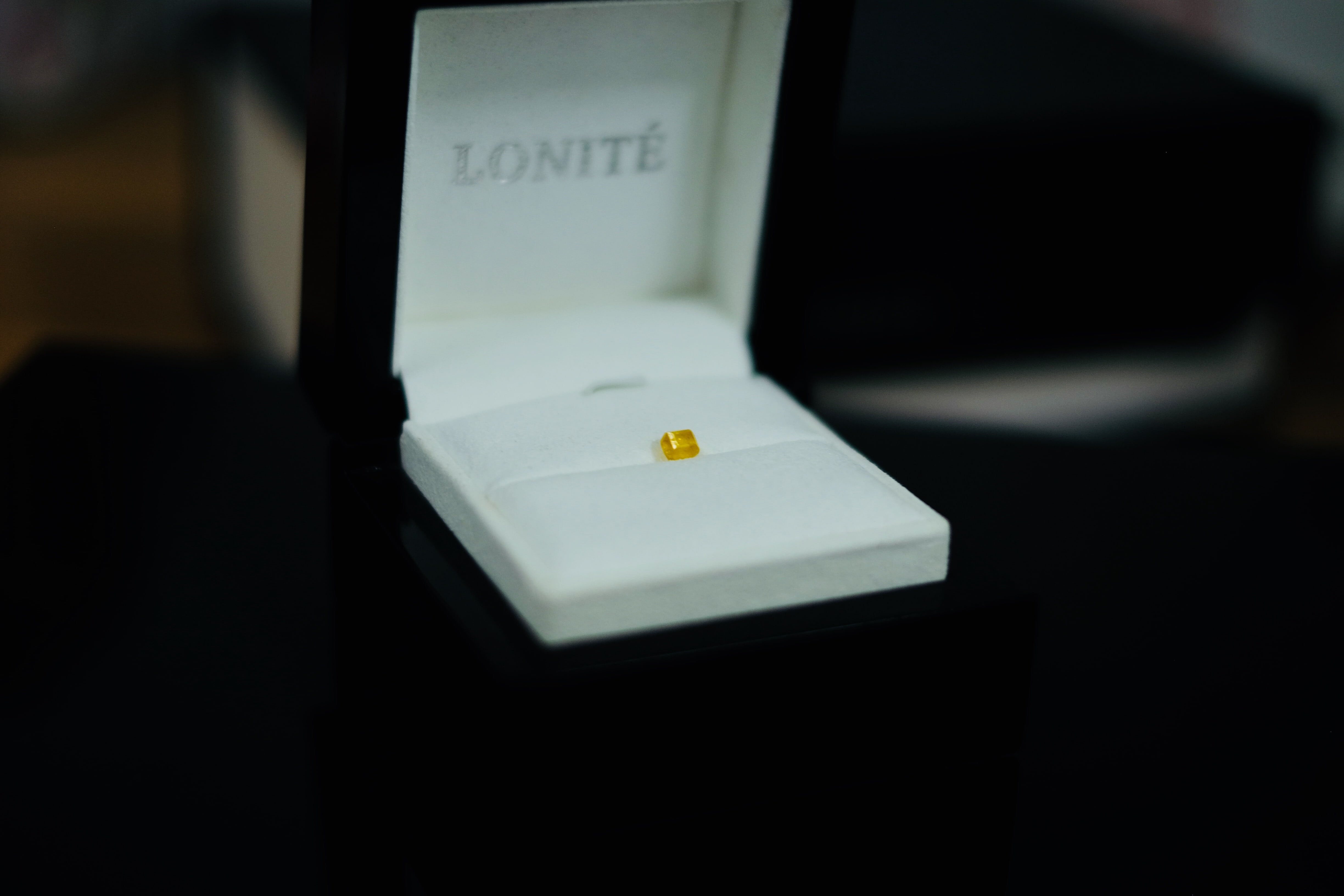 An unpolished amber LONITÉ memorial diamond from ashes made out of human cremated remains or hair.